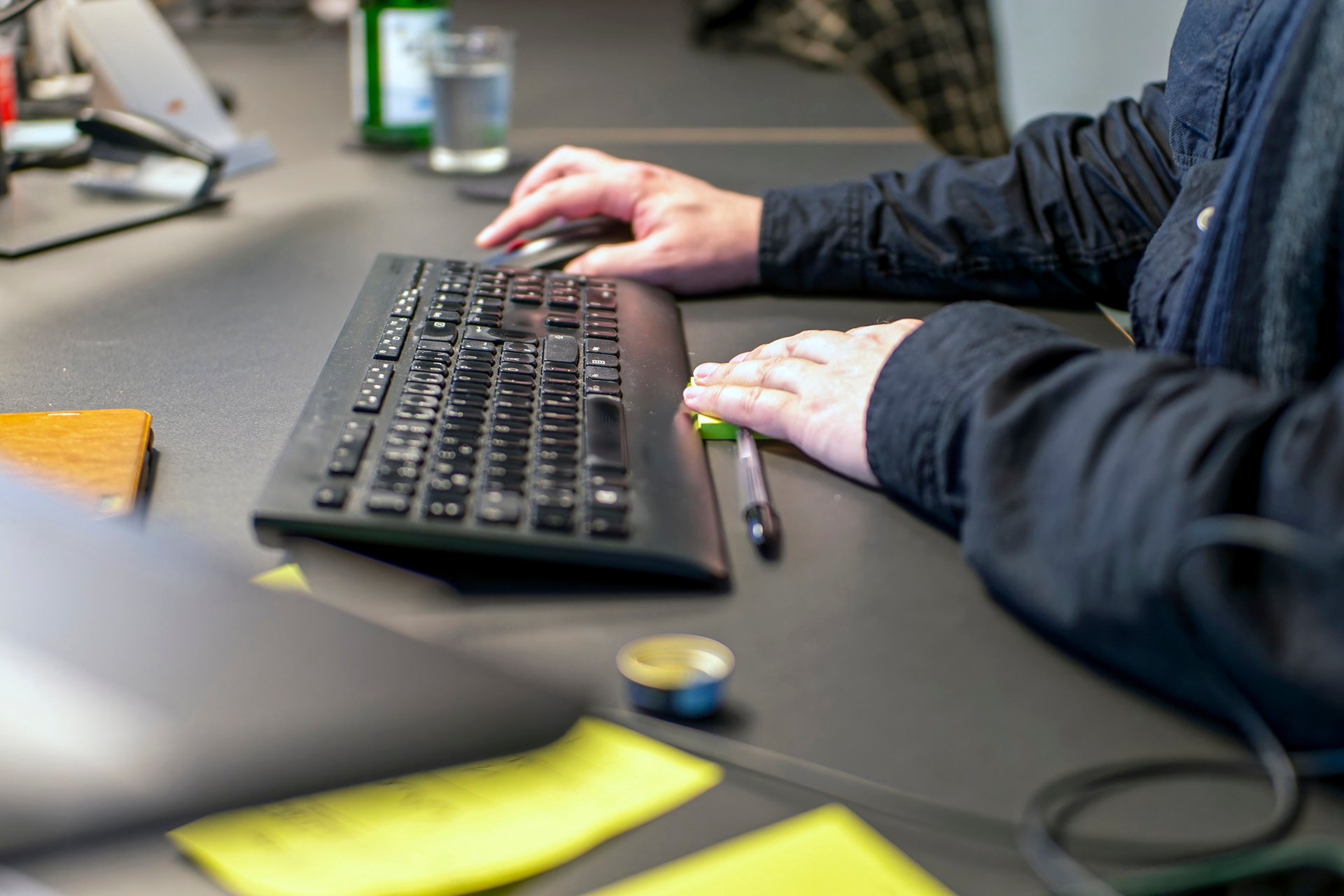 Eine männliche Person arbeitet am Computer am Vertragsmanagement